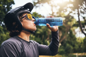 Athlete staying hydrated with water during a workout, highlighting the importance of hydration for both fitness and dental health.