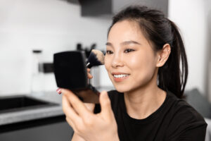 Person practicing their smile in front of a mirror.